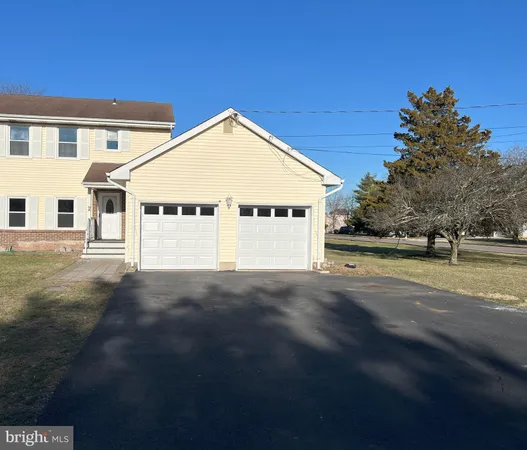 a view of a large white house with a yard