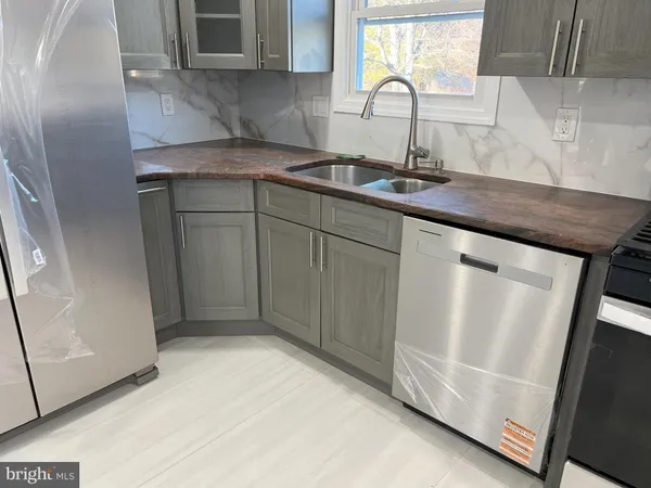 a toilet sitting in a bathroom next to a sink
