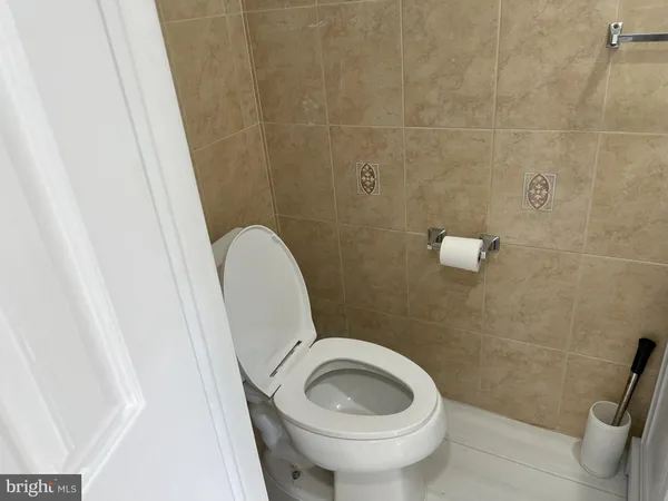 a bathroom with a granite countertop toilet and a sink