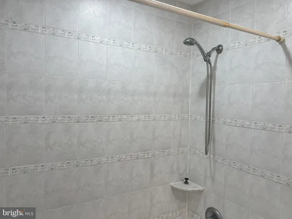 a bathroom with a glass shower door