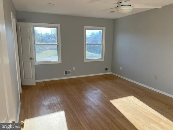 a view of room with window and a ceiling fan