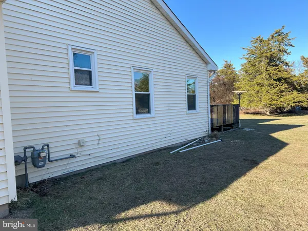 a view of a yard with wooden fence