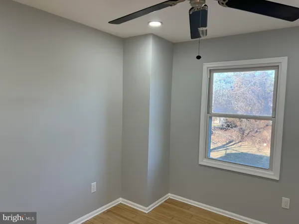 a view of a livingroom with an empty space and a window