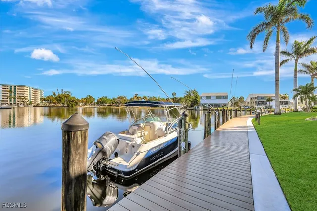 a view of a lake with couches chairs