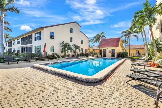 a view of swimming pool with outdoor seating