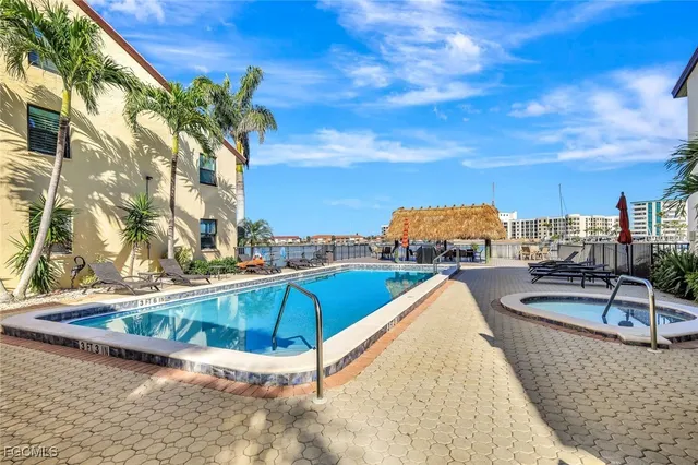 a swimming pool with outdoor seating and yard
