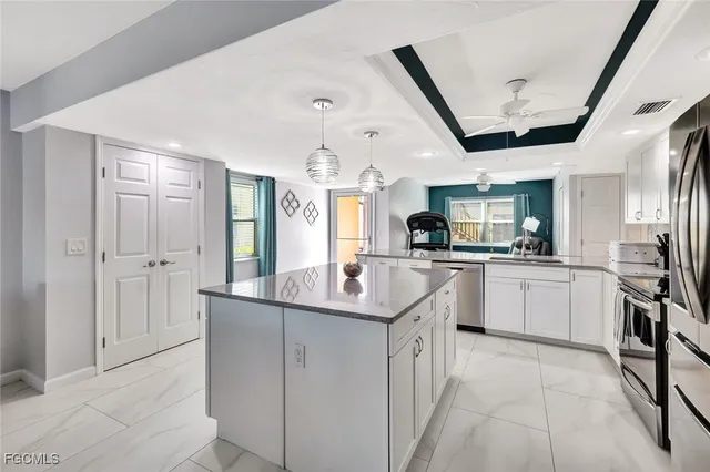 a kitchen with stainless steel appliances granite countertop a sink and refrigerator