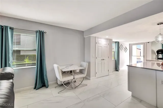 a living room with a chair and a large window