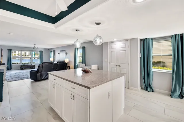 a view of a kitchen center island and living room