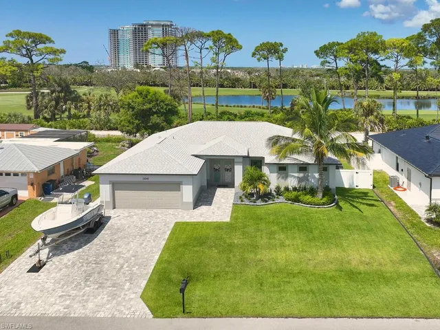 an aerial view of a house with swimming pool garden and patio