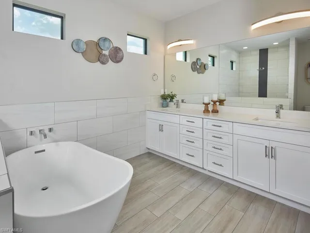 a spacious bathroom with a double vanity sink and a mirror
