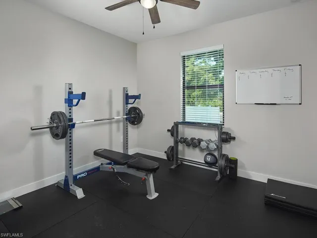 a room with gym equipment and windows