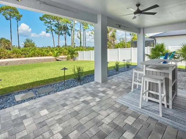 a view of a porch with furniture and garden