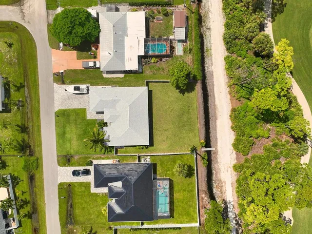 an aerial view of residential houses with outdoor space