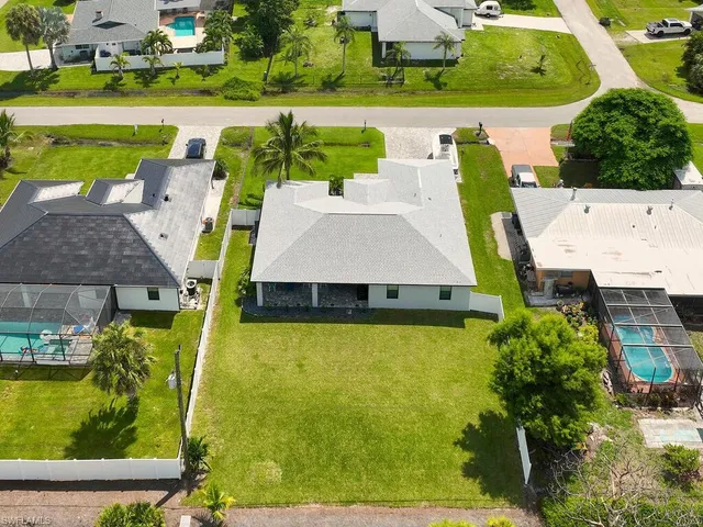 an aerial view of a house with a swimming pool