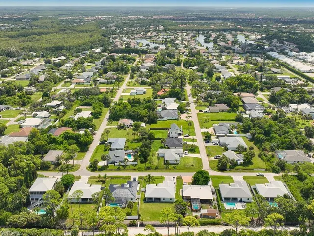 an aerial view of residential houses with outdoor space