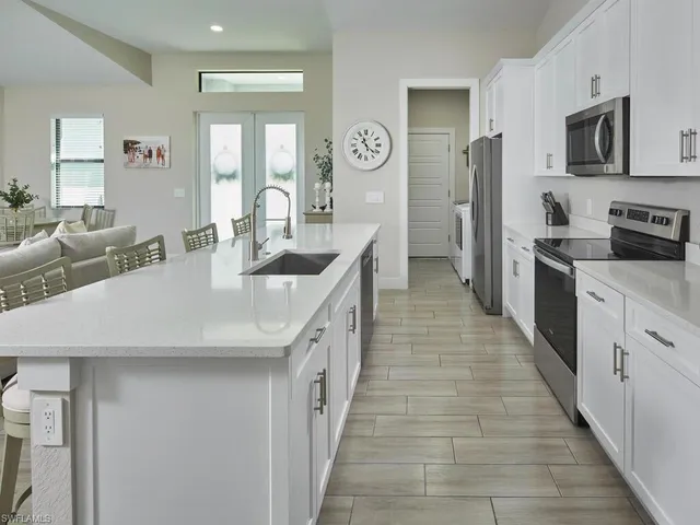 a kitchen with stainless steel appliances granite countertop a sink and dishwasher