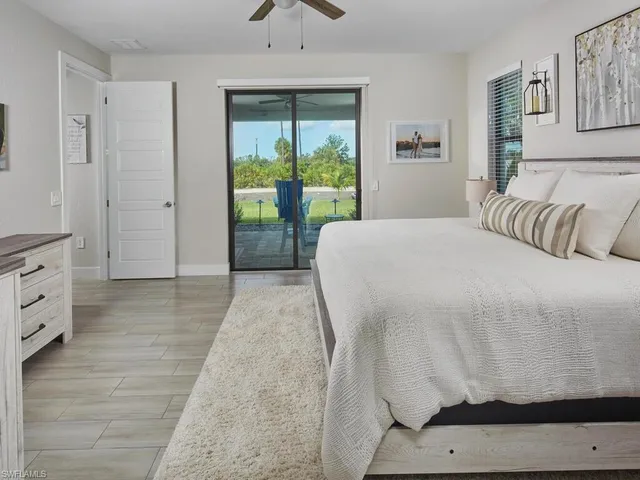 a bed sitting in a bedroom next to a window