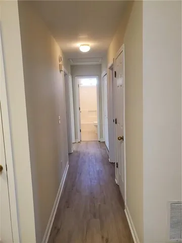 a view of a hallway with wooden floor