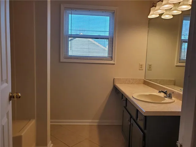 a bathroom with a sink a vanity and a mirror