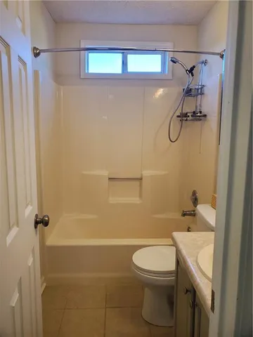 a bathroom with a toilet a sink and shower