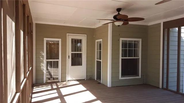 a view of interior space with wooden floor and a ceiling fan