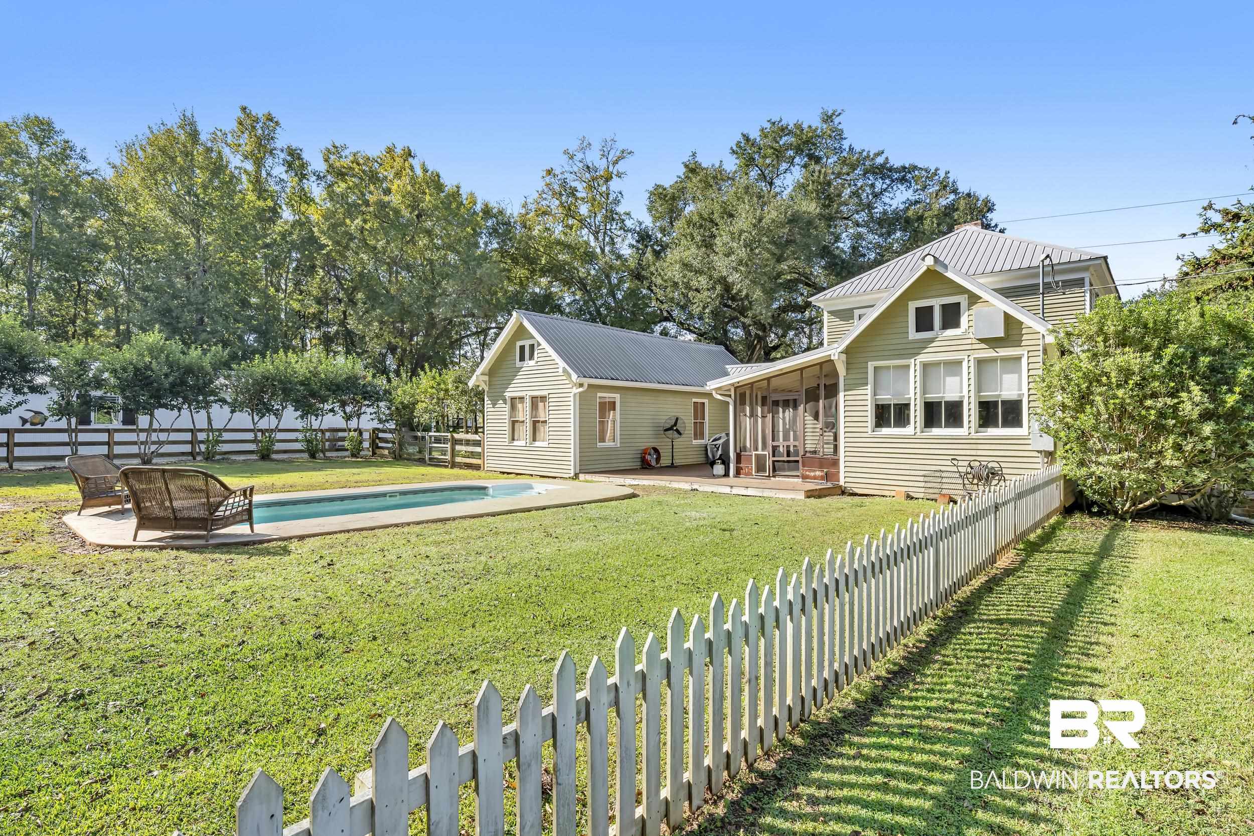 13232 Mary Ann Bch Road Fairhope, AL 36532 - Photo 4 of 79 Back of property with a fenced backyard, a sunroom, and a patio