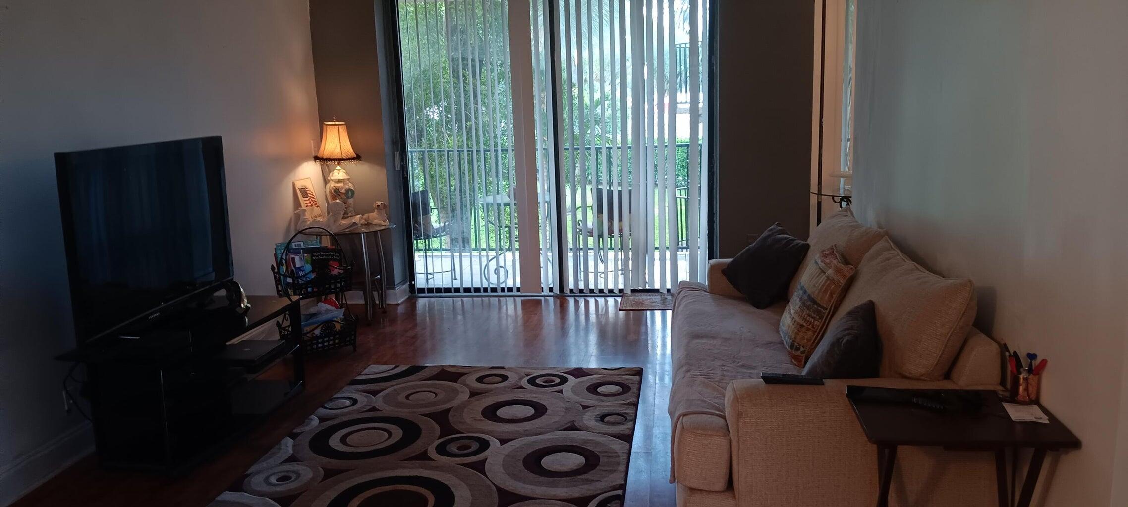 3450 Blue Lake Drive, Unit 204 Pompano Beach, FL 33064 - Photo 14 of 18 a view of a entryway with furniture and floor to ceiling window