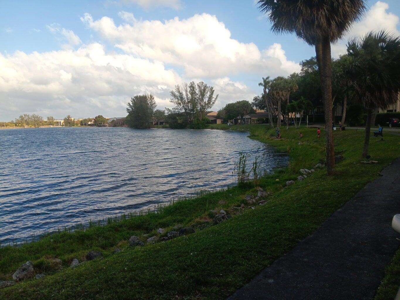 3450 Blue Lake Drive, Unit 204 Pompano Beach, FL 33064 - Photo 4 of 18 a view of a lake from a yard