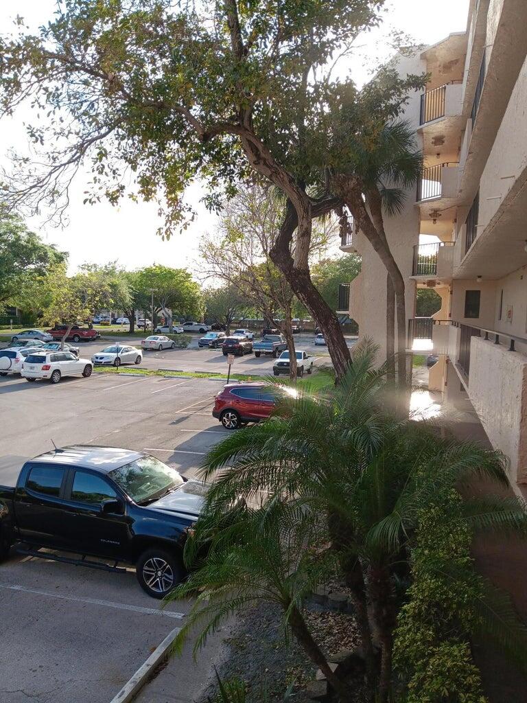 3450 Blue Lake Drive, Unit 204 Pompano Beach, FL 33064 - Photo 6 of 18 a car parked on the side of the road