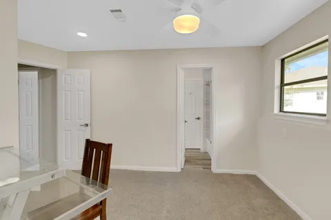 a bedroom with furniture and wooden floor