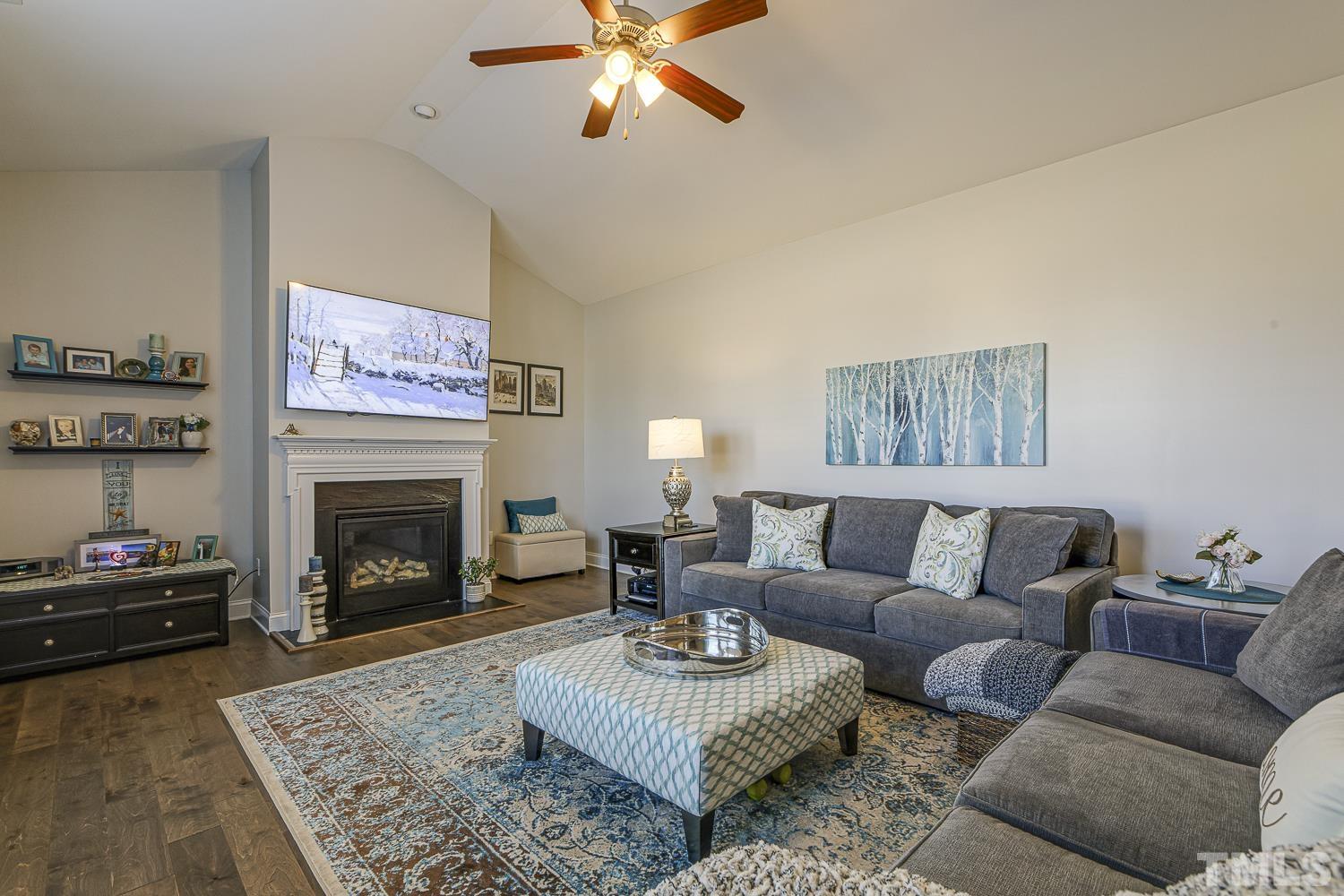 5516 Red Line Court Raleigh, NC 27603 - Photo 13 of 39 a living room with furniture and a fireplace