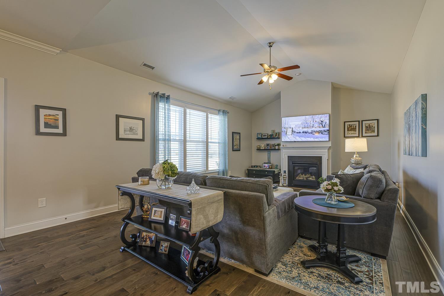5516 Red Line Court Raleigh, NC 27603 - Photo 14 of 39 a living room with furniture a window and a fireplace
