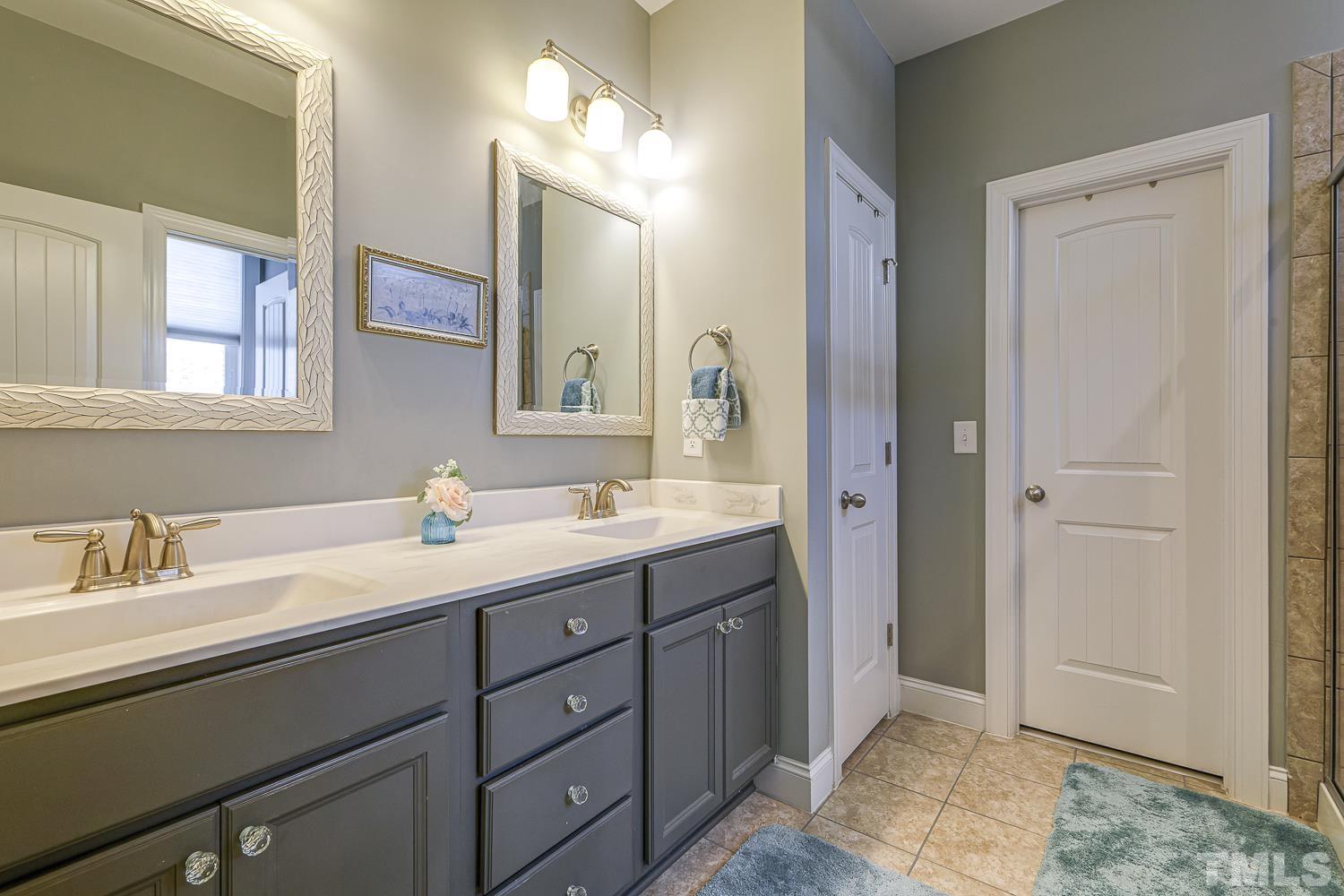 5516 Red Line Court Raleigh, NC 27603 - Photo 19 of 39 a en suite bathroom with a sink and a mirror