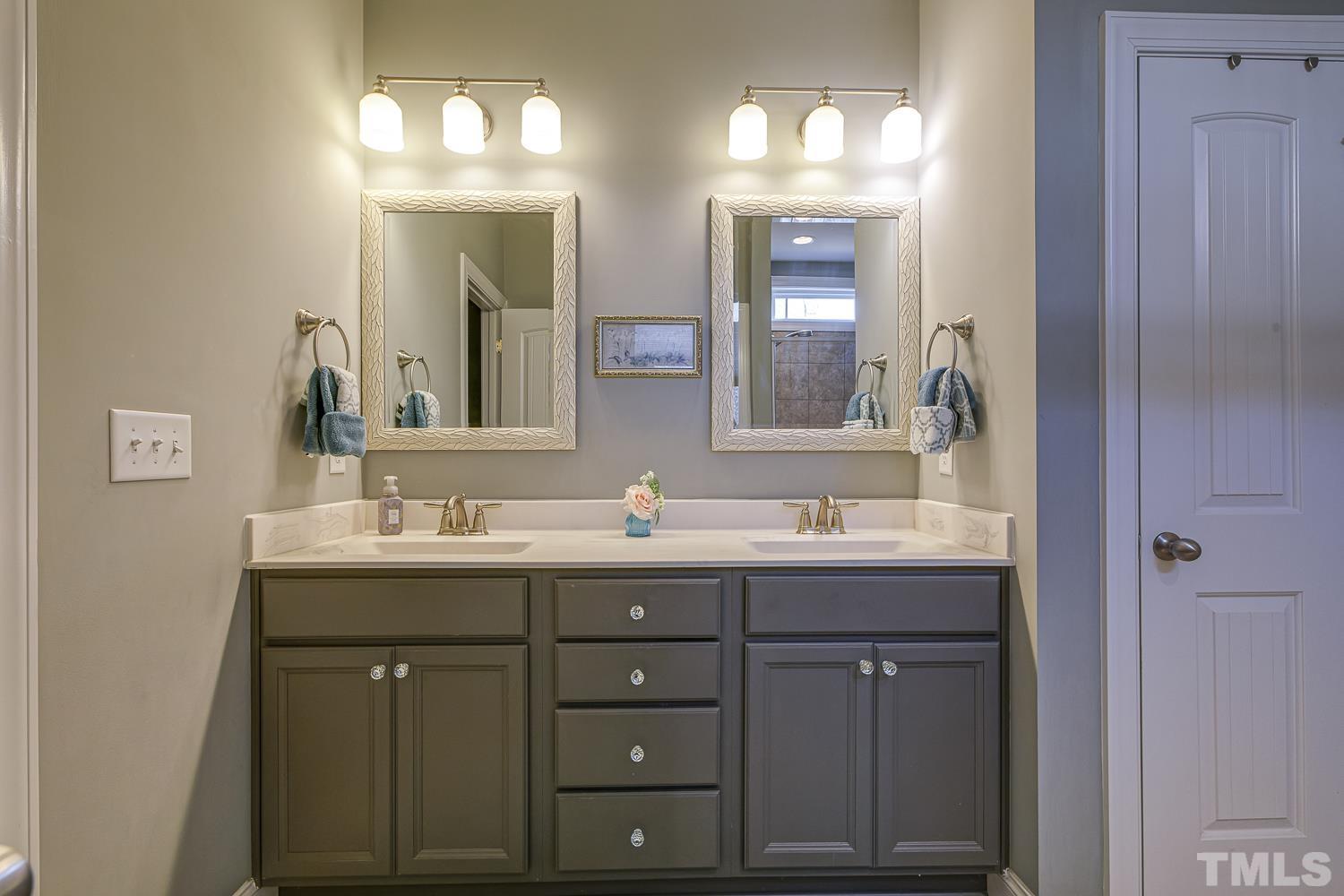 5516 Red Line Court Raleigh, NC 27603 - Photo 20 of 39 a bathroom with a double vanity sink and a mirror