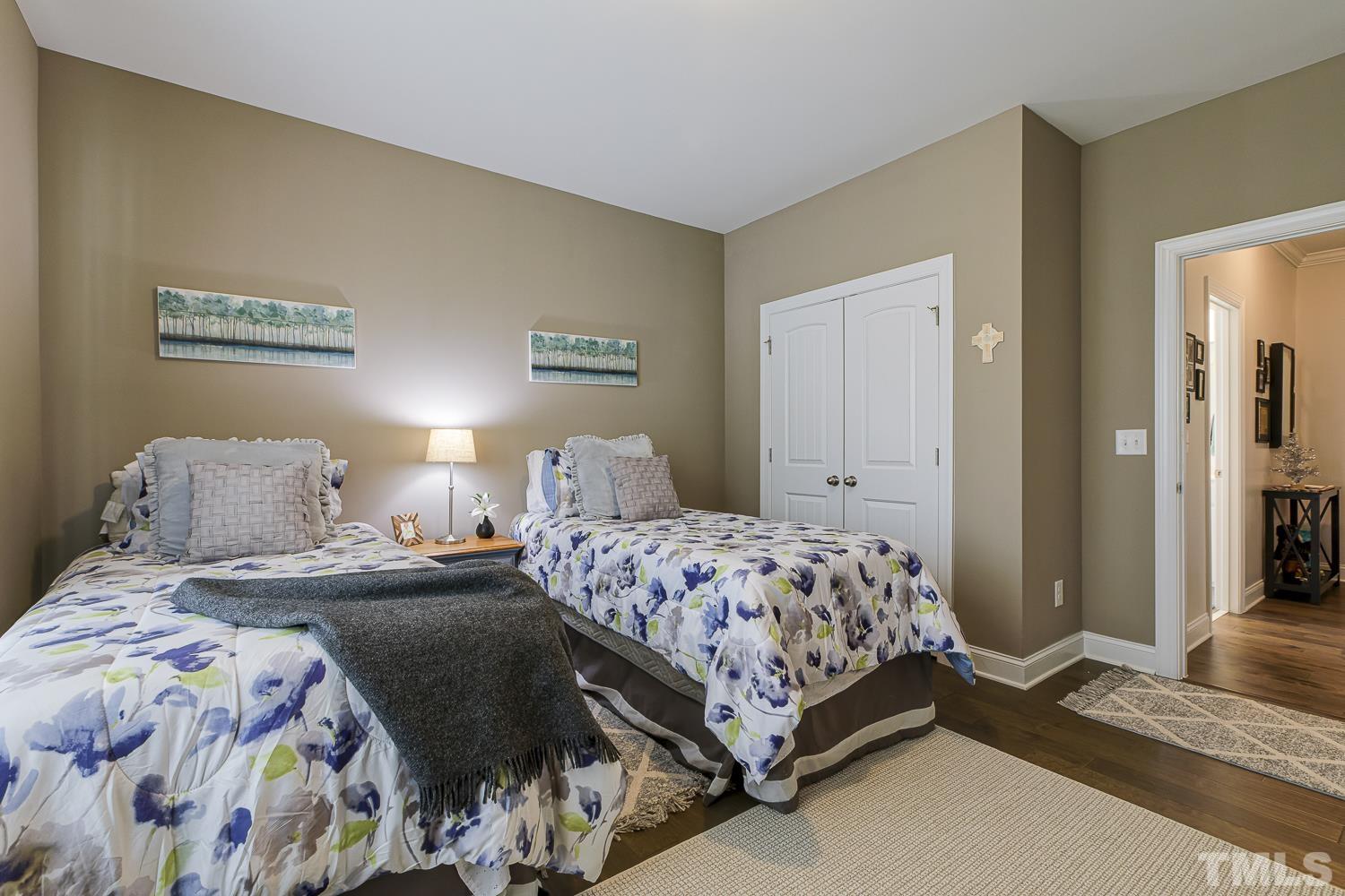 5516 Red Line Court Raleigh, NC 27603 - Photo 23 of 39 a bedroom with a bed and a chandelier