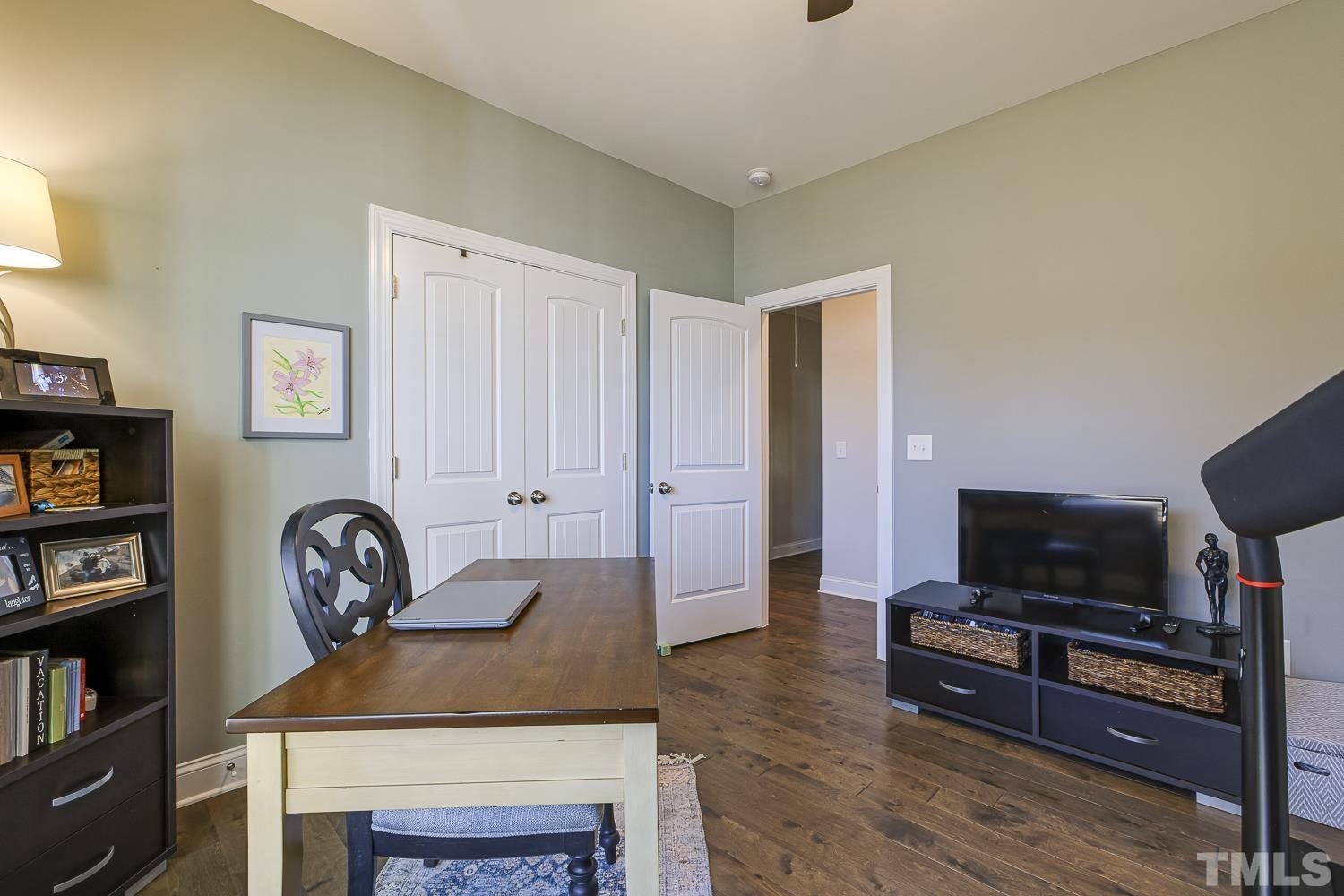 5516 Red Line Court Raleigh, NC 27603 - Photo 26 of 39 a living room with furniture a flat screen tv and a fireplace