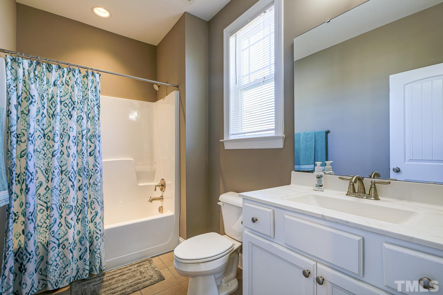 5516 Red Line Court Raleigh, NC 27603 - Photo 30 of 39 a bathroom with a sink toilet and shower