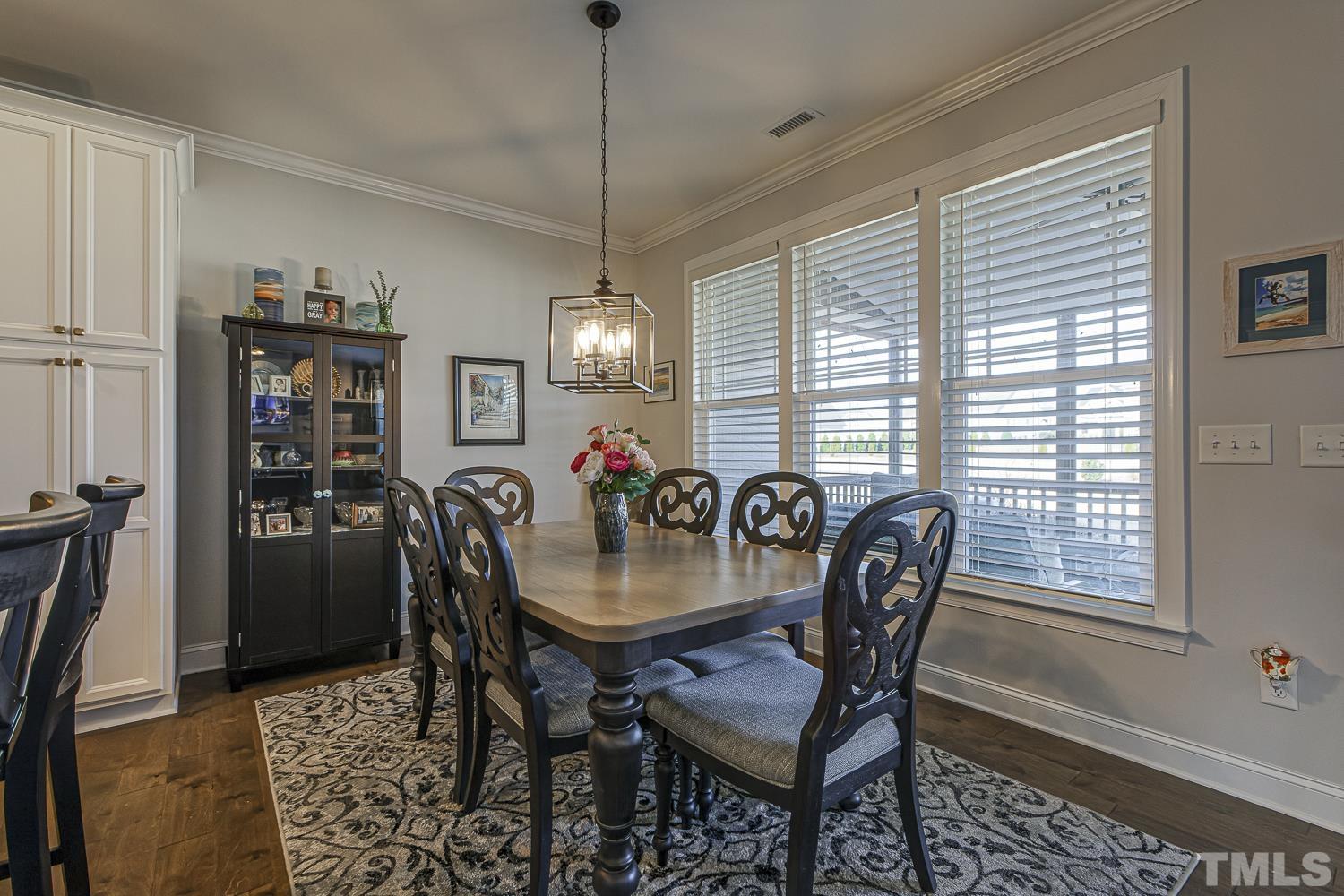 5516 Red Line Court Raleigh, NC 27603 - Photo 10 of 39 a dining room with furniture a chandelier and window