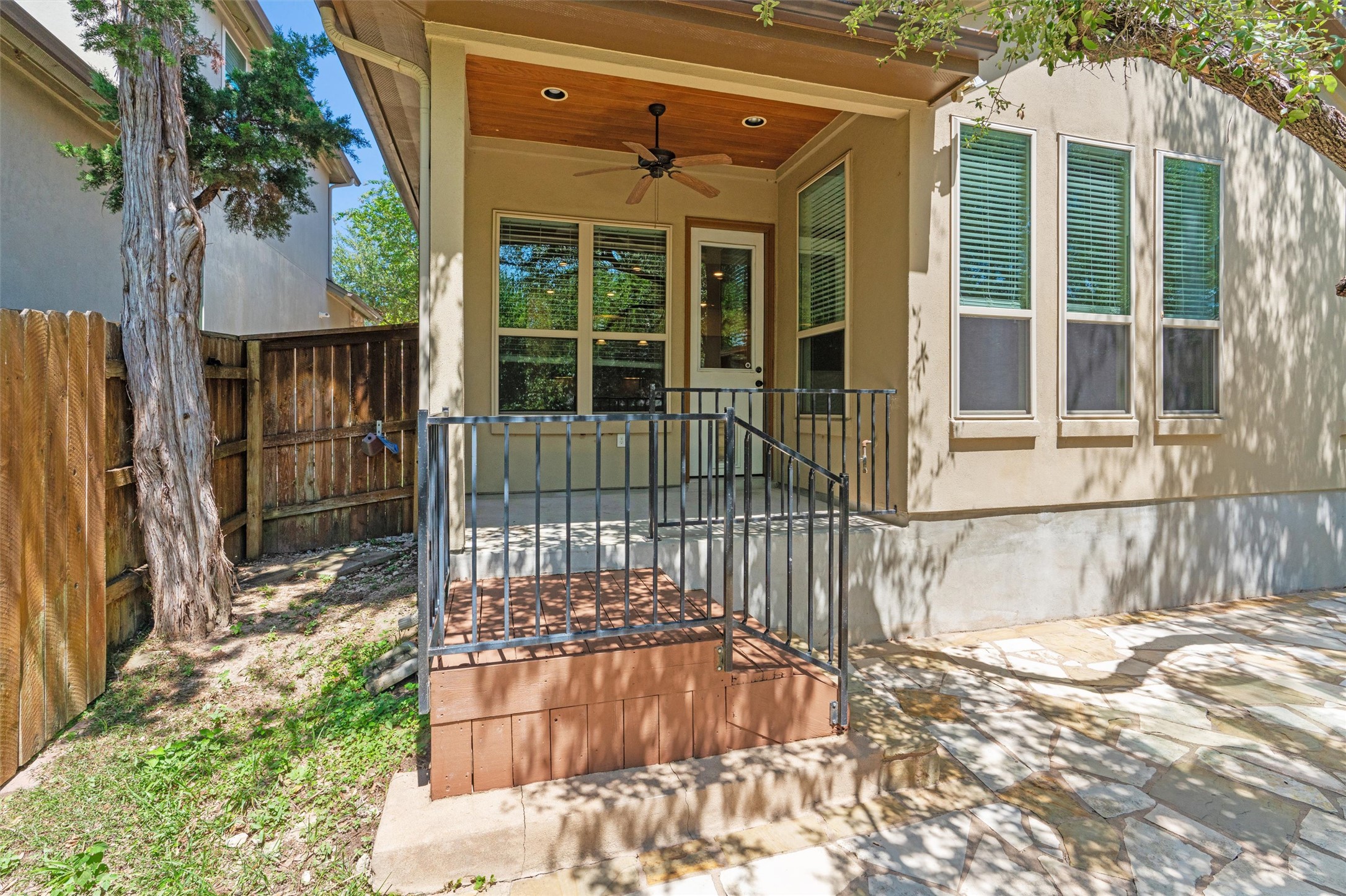 8417 Etienne Cove Austin, TX 78759 - Photo 30 of 35 A welcoming covered patio with an outdoor ceiling fan offers a comfortable spot for outdoor relaxation.