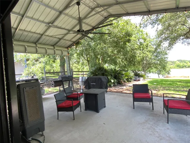 a view of living room with patio furniture and a potted plant