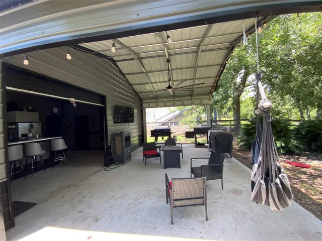 a kitchen with a table chairs refrigerator and microwave