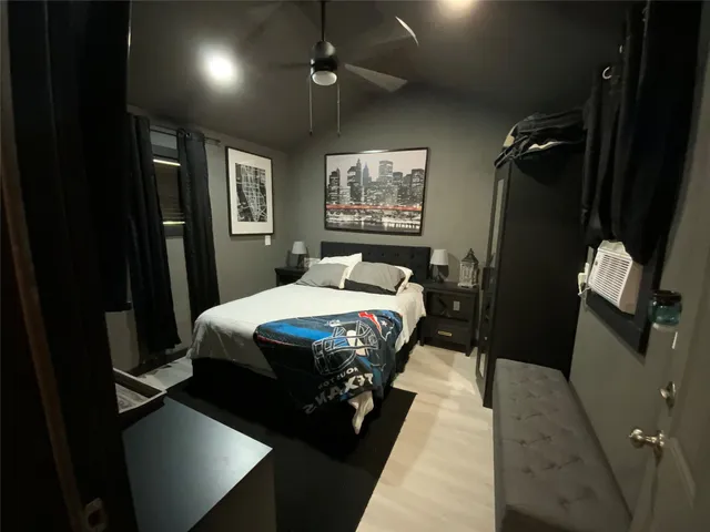 a living room with furniture and a glass table with stainless steel appliances