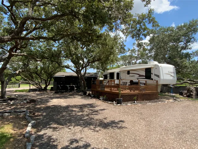a living room with furniture a flat screen tv and a large window