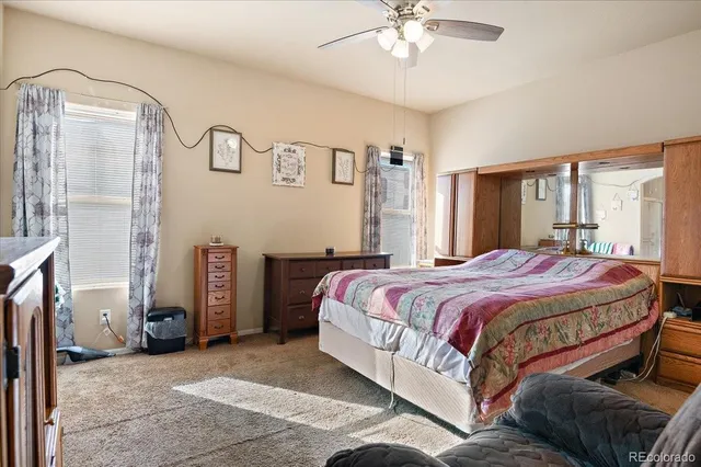 a bathroom with a granite countertop sink a mirror and a shower