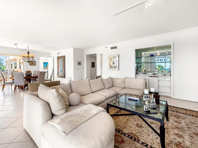 a living room with furniture wooden floor and a large window