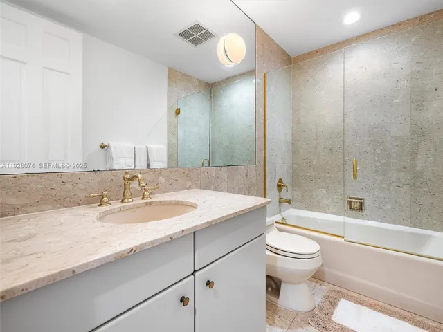 a bedroom with a bed and a mirror