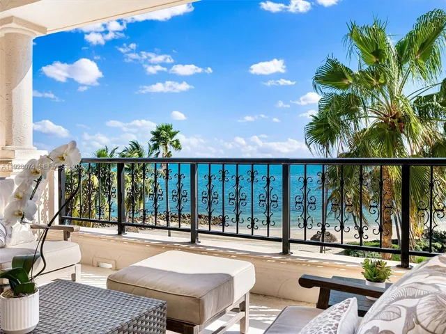 a swimming pool with outdoor seating and a potted plant