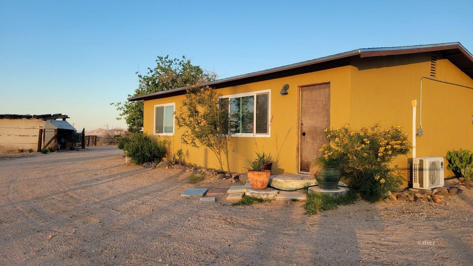 4047 Felspar Avenue Ridgecrest, CA 93555 - Photo 25 of 49 a backyard of a house with table and chairs