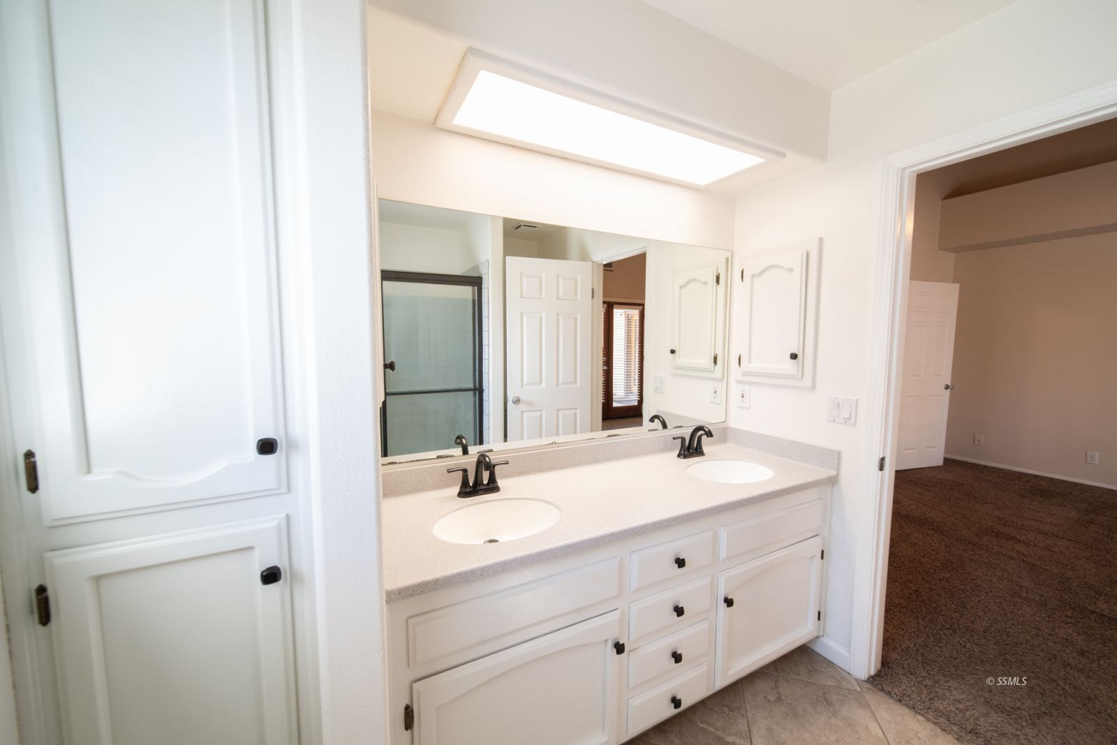 1205 Flora Way Ridgecrest, CA 93555 - Photo 26 of 46 a bathroom with a double vanity sink and mirror